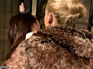 Kathia Nobili in furry jacket torturing a red-hot babe