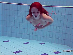 red-haired dancing in the pool